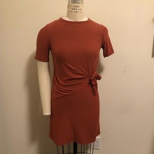 Rust colored knit dress with front drape & tie